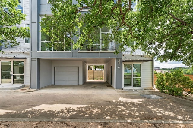 1500 Summit St Unit 4, Austin, TX 78741 - view of front of home featuring an attached garage and a carport