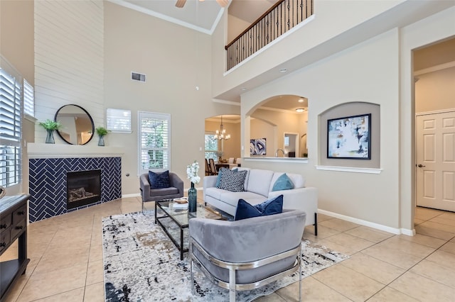 2503 Kinclaven Ct, Cedar Park, TX 78613 - living room featuring light tile patterned floors, a tile fireplace, a chandelier, a high ceiling, and baseboards