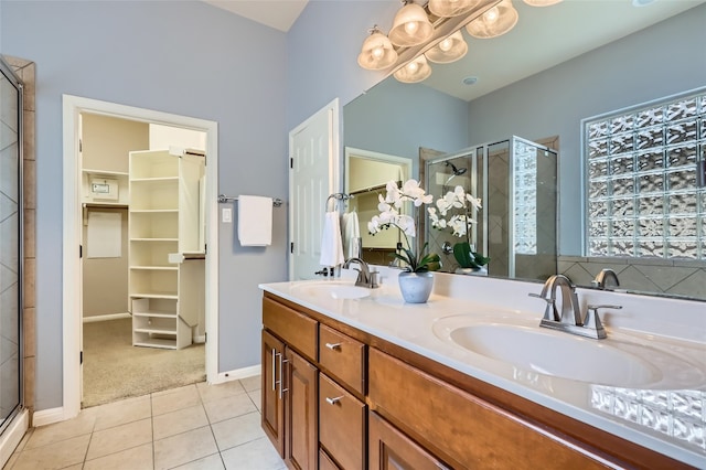 2503 Kinclaven Ct, Cedar Park, TX 78613 - full bath with a shower stall, a walk in closet, double vanity, and tile patterned flooring