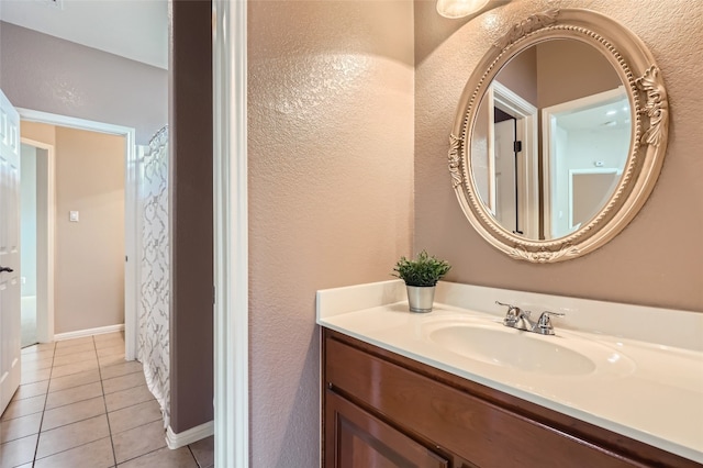 2503 Kinclaven Ct, Cedar Park, TX 78613 - bathroom featuring vanity, tile patterned flooring, a textured wall, and baseboards