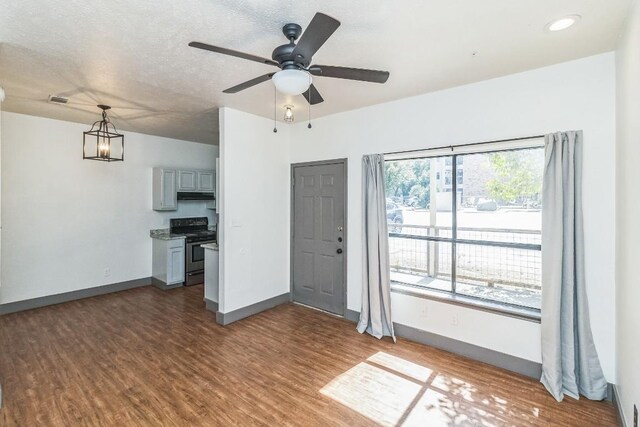 421 W San Antonio St Unit H1, San Marcos, TX 78666 - unfurnished living room with dark wood-type flooring, a ceiling fan, and recessed lighting