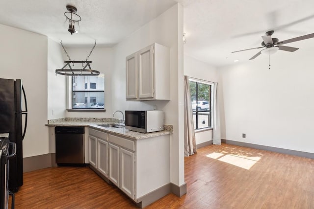 421 W San Antonio St Unit H1, San Marcos, TX 78666 - kitchen with dishwasher, a sink, freestanding refrigerator, dark wood-style floors, and a ceiling fan