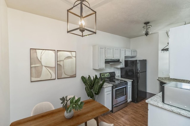421 W San Antonio St Unit H1, San Marcos, TX 78666 - kitchen with electric stove, under cabinet range hood, freestanding refrigerator, dark wood-type flooring, and pendant lighting