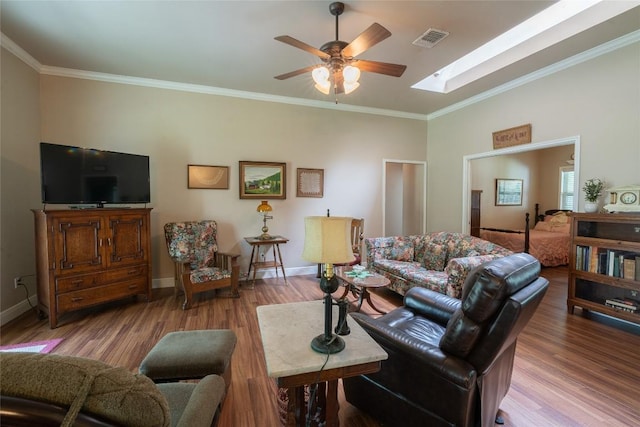 11525 Fm 86th Rd, Lockhart, TX 78644 - living area with ceiling fan, wood finished floors, a skylight, crown molding, and baseboards