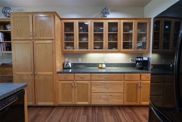 11525 Fm 86th Rd, Lockhart, TX 78644 - kitchen with black appliances, dark wood-style flooring, glass insert cabinets, and dark countertops