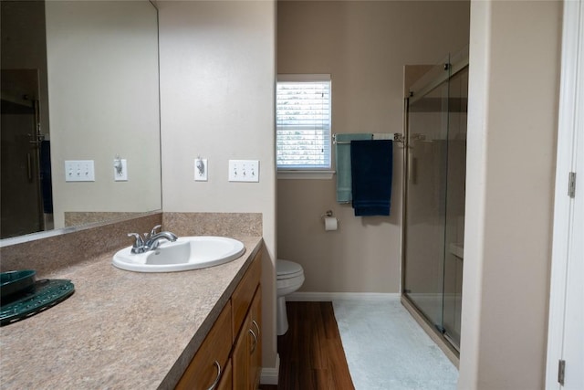 11525 Fm 86th Rd, Lockhart, TX 78644 - full bathroom featuring vanity, a shower stall, wood finished floors, and baseboards