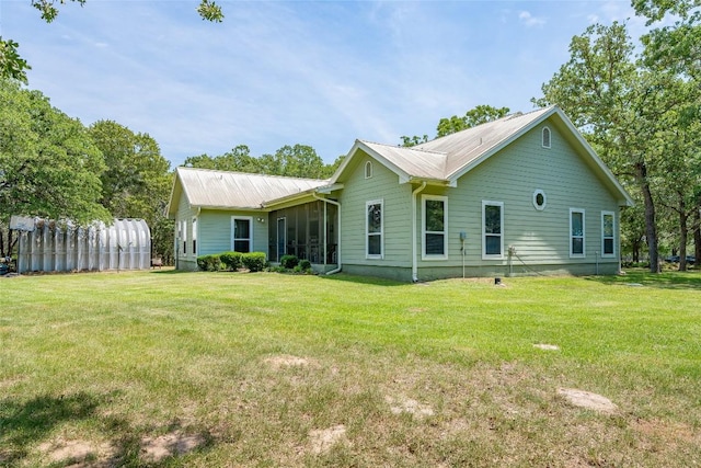 11525 Fm 86th Rd, Lockhart, TX 78644 - back of property featuring a sunroom, a lawn, and metal roof