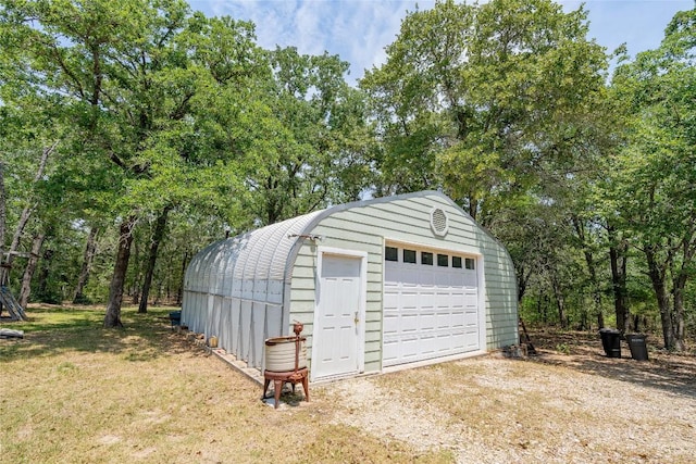 11525 Fm 86th Rd, Lockhart, TX 78644 - detached garage with dirt driveway and view of wooded area
