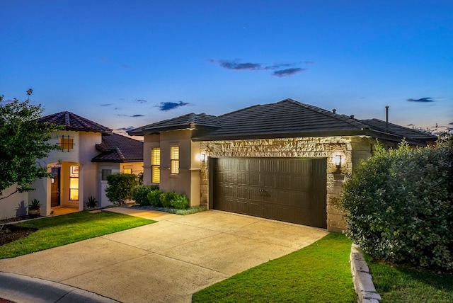 5502 Patagonia Pass, Austin, TX 78738 - view of front of house featuring a tiled roof, an attached garage, stucco siding, concrete driveway, and a front yard