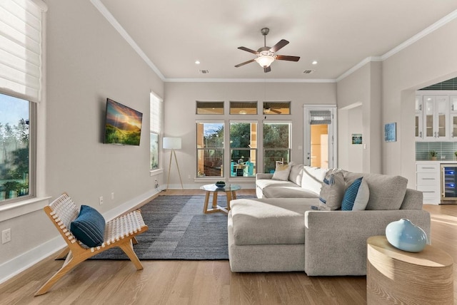 5502 Patagonia Pass, Austin, TX 78738 - living area with wine cooler, healthy amount of natural light, wood finished floors, a dry bar, and crown molding