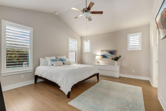 5502 Patagonia Pass, Austin, TX 78738 - bedroom featuring multiple windows, wood finished floors, vaulted ceiling, and a ceiling fan