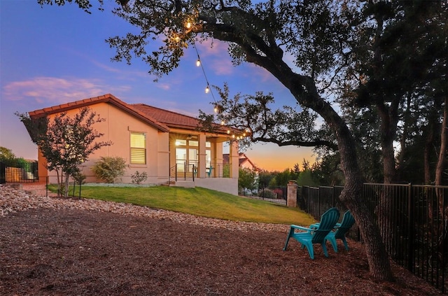 5502 Patagonia Pass, Austin, TX 78738 - rear view of property featuring a tiled roof and stucco siding