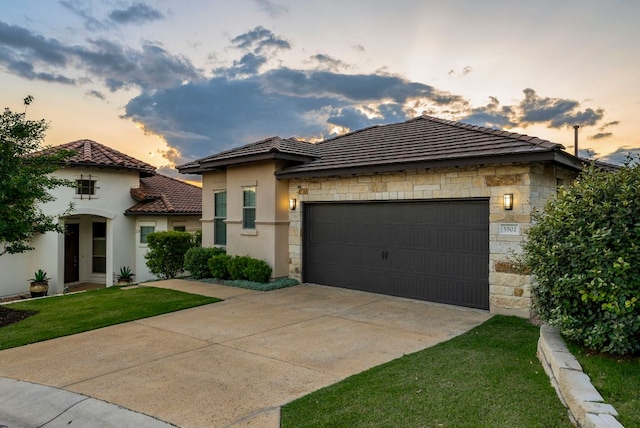 5502 Patagonia Pass, Austin, TX 78738 - view of front of house featuring a tile roof, an attached garage, stone siding, stucco siding, and concrete driveway