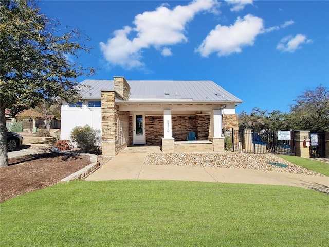 5502 Patagonia Pass, Austin, TX 78738 - view of front facade with stone siding, a metal roof, and a standing seam roof