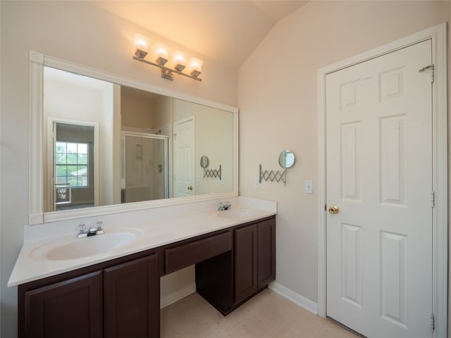 1010 Barclay Dr, Leander, TX 78641 - bathroom with double vanity, a shower stall, lofted ceiling, and baseboards