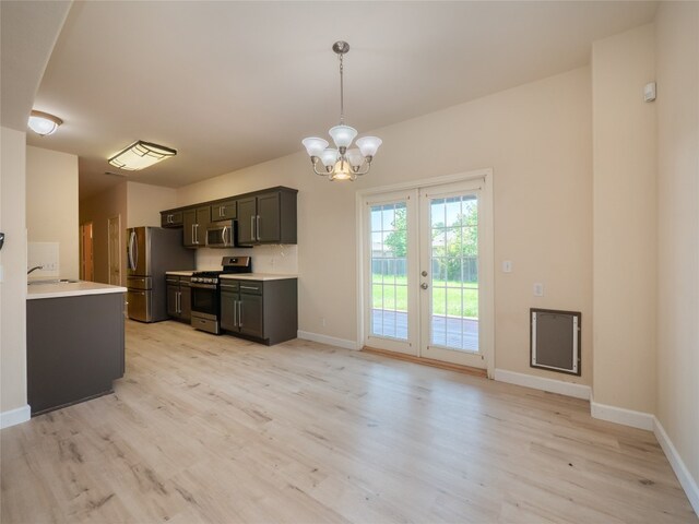1010 Barclay Dr, Leander, TX 78641 - kitchen with stainless steel appliances, light wood-style flooring, light countertops, a chandelier, and baseboards