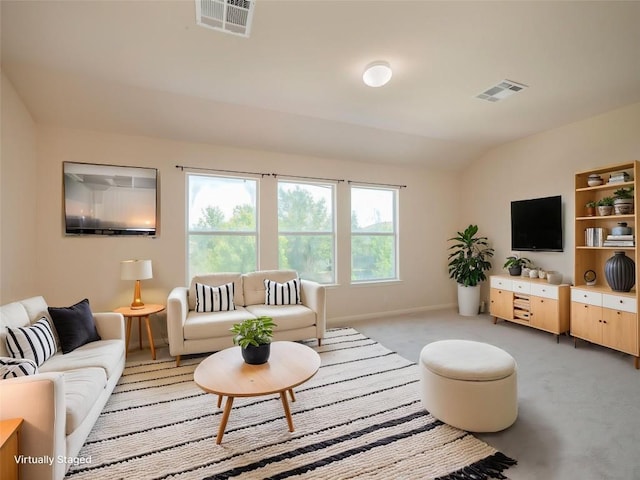 1010 Barclay Dr, Leander, TX 78641 - living room featuring light carpet, lofted ceiling, and baseboards