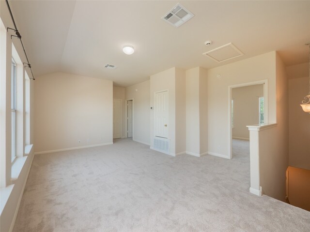 1010 Barclay Dr, Leander, TX 78641 - empty room with light carpet, healthy amount of natural light, lofted ceiling, and baseboards