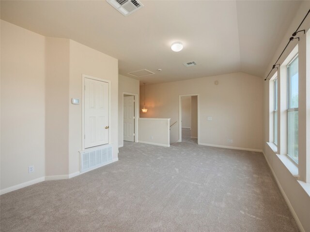 1010 Barclay Dr, Leander, TX 78641 - spare room featuring light carpet, lofted ceiling, and baseboards