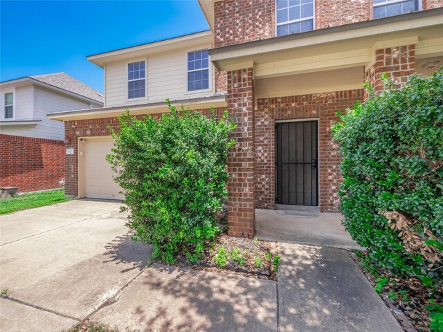 1010 Barclay Dr, Leander, TX 78641 - entrance to property with brick siding, a garage, and driveway