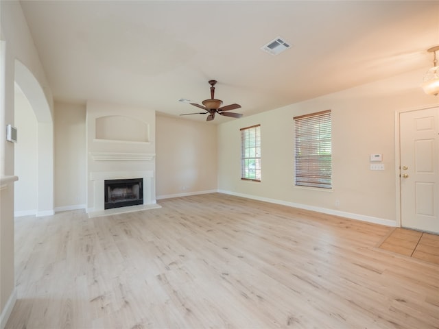 1010 Barclay Dr, Leander, TX 78641 - unfurnished living room with light wood finished floors, a fireplace, a ceiling fan, and baseboards