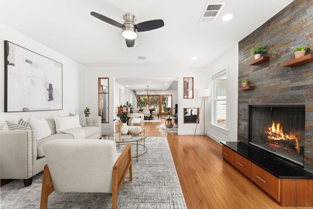 2004 Bremen St, Austin, TX 78703 - living area with a large fireplace, light wood-type flooring, a ceiling fan, baseboards, and recessed lighting