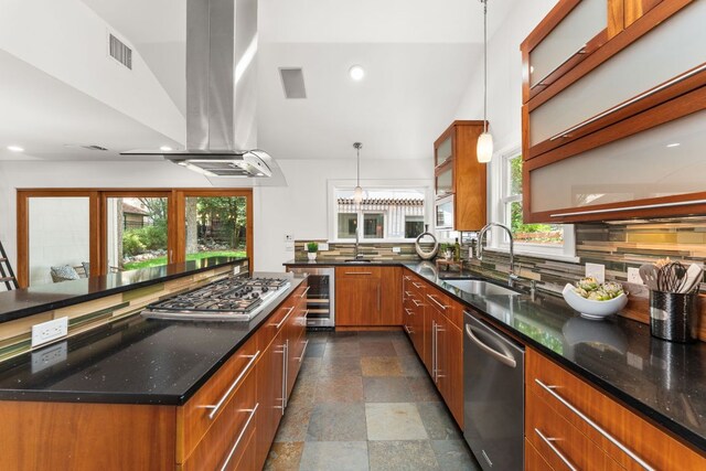 2004 Bremen St, Austin, TX 78703 - kitchen with stainless steel appliances, a sink, island exhaust hood, brown cabinets, and beverage cooler