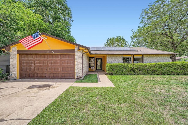 7900 Keneshaw Dr, Austin, TX 78745 - mid-century modern home featuring stone siding, an attached garage, solar panels, a front yard, and driveway