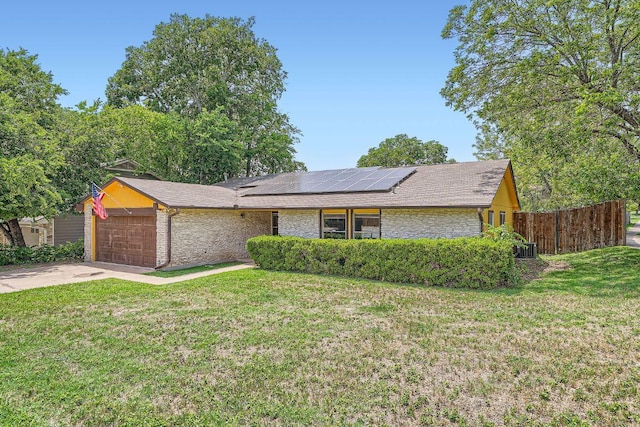 7900 Keneshaw Dr, Austin, TX 78745 - mid-century home with an attached garage, solar panels, driveway, stone siding, and roof with shingles