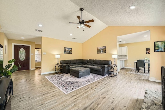 7900 Keneshaw Dr, Austin, TX 78745 - living room featuring light wood-type flooring, a ceiling fan, vaulted ceiling, recessed lighting, and baseboards