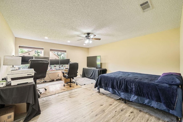 7900 Keneshaw Dr, Austin, TX 78745 - bedroom featuring wood finished floors, an office area, a textured ceiling, recessed lighting, and a ceiling fan