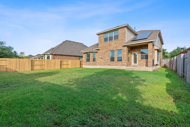 2809 Coral Valley Dr, Leander, TX 78641 - back of property with roof mounted solar panels, brick siding, and roof with shingles