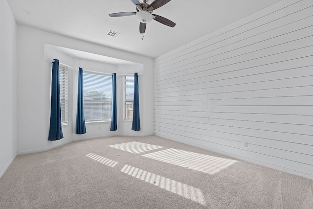 2809 Coral Valley Dr, Leander, TX 78641 - carpeted empty room with a ceiling fan and wood walls