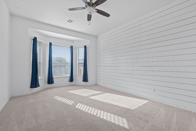 2809 Coral Valley Dr, Leander, TX 78641 - empty room featuring ceiling fan, carpet flooring, and wooden walls