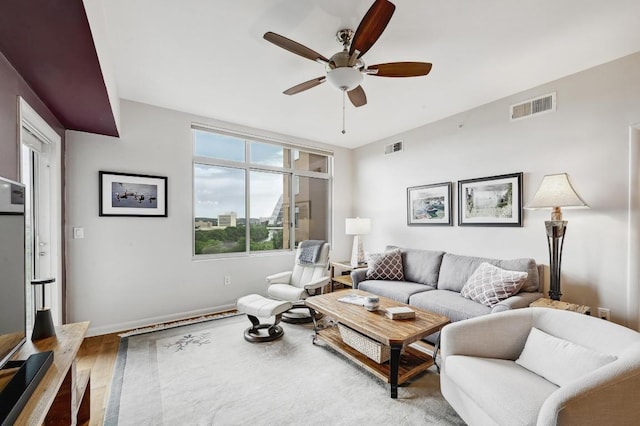 54 Rainey St Unit 814, Austin, TX 78701 - living area with a ceiling fan, wood finished floors, and baseboards