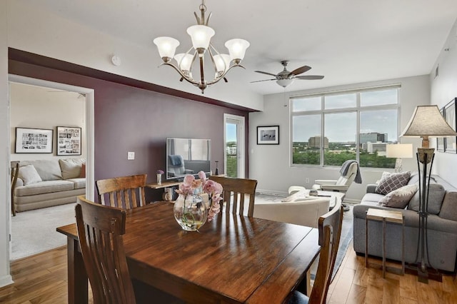54 Rainey St Unit 814, Austin, TX 78701 - dining space with a ceiling fan, wood-type flooring, and a chandelier