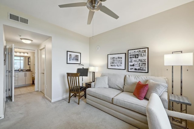 54 Rainey St Unit 814, Austin, TX 78701 - living area featuring light colored carpet, a ceiling fan, and baseboards
