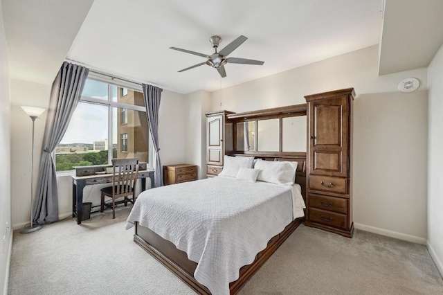 54 Rainey St Unit 814, Austin, TX 78701 - bedroom featuring light colored carpet, baseboards, ceiling fan, and a desk
