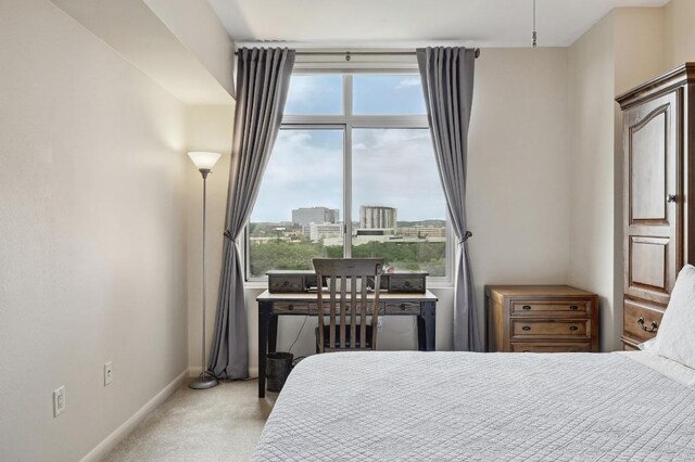 54 Rainey St Unit 814, Austin, TX 78701 - bedroom featuring multiple windows, carpet, and baseboards