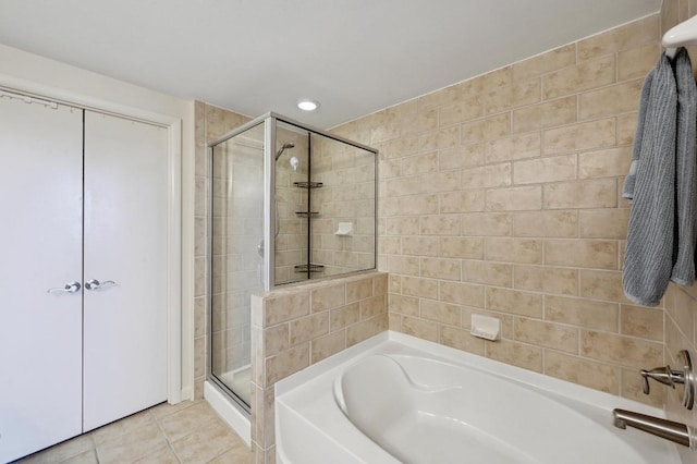 54 Rainey St Unit 814, Austin, TX 78701 - bathroom featuring a stall shower, a garden tub, tile patterned floors, and recessed lighting