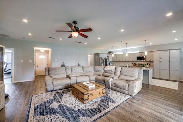 211 Spring Garden Dr, Hutto, TX 78634 - living area featuring ceiling fan, light wood finished floors, recessed lighting, and baseboards