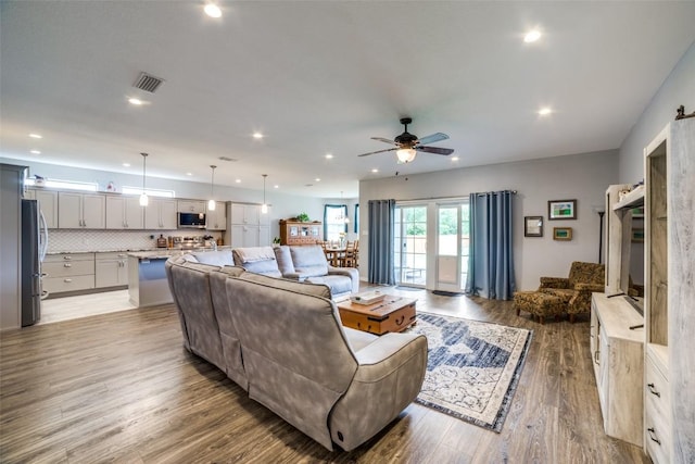 211 Spring Garden Dr, Hutto, TX 78634 - living area featuring a ceiling fan, wood finished floors, and recessed lighting