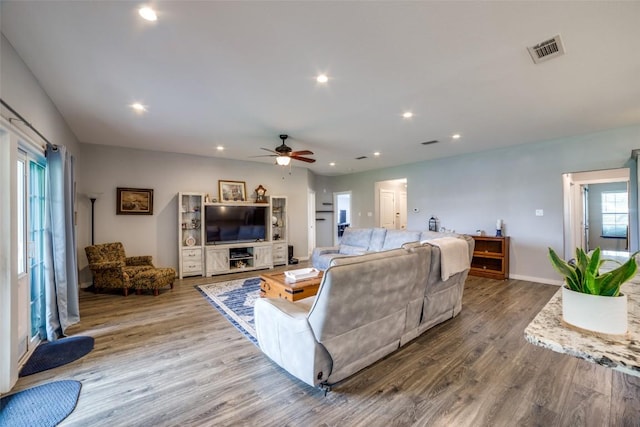 211 Spring Garden Dr, Hutto, TX 78634 - living area with wood finished floors, a ceiling fan, recessed lighting, and baseboards