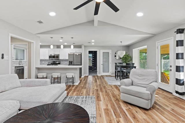 3312 Broken Spoke Trl, Georgetown, TX 78628 - living room featuring light wood finished floors, ceiling fan, and recessed lighting