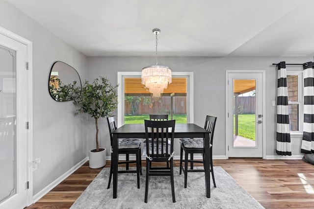 3312 Broken Spoke Trl, Georgetown, TX 78628 - dining area with a chandelier, wood finished floors, and baseboards