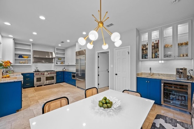 3101 Fleece Flower Cv, Austin, TX 78735 - dining space with beverage cooler, stone tile flooring, wet bar, and recessed lighting