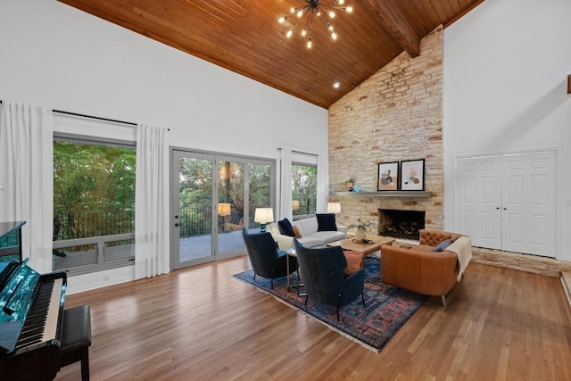 3101 Fleece Flower Cv, Austin, TX 78735 - living room with high vaulted ceiling, healthy amount of natural light, wood ceiling with exposed beams, wood finished floors, and a stone fireplace