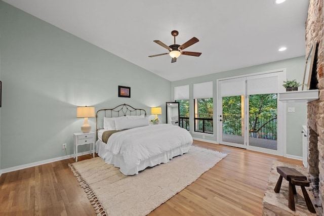 3101 Fleece Flower Cv, Austin, TX 78735 - bedroom featuring a fireplace, access to exterior, wood finished floors, vaulted ceiling, and baseboards