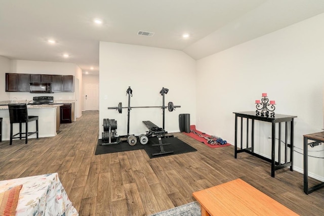 15000 Upland Willow Rd, Austin, TX 78724 - workout room with wood finished floors, recessed lighting, baseboards, and vaulted ceiling