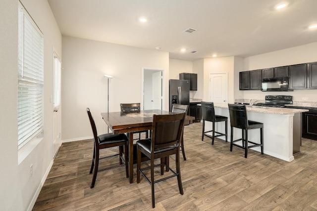 15000 Upland Willow Rd, Austin, TX 78724 - dining room featuring wood finished floors, recessed lighting, baseboards, and plenty of natural light